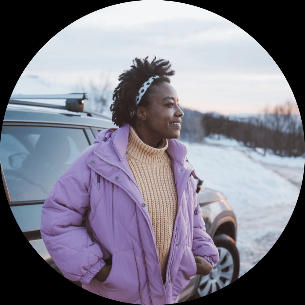 person standing by a car in the snow
