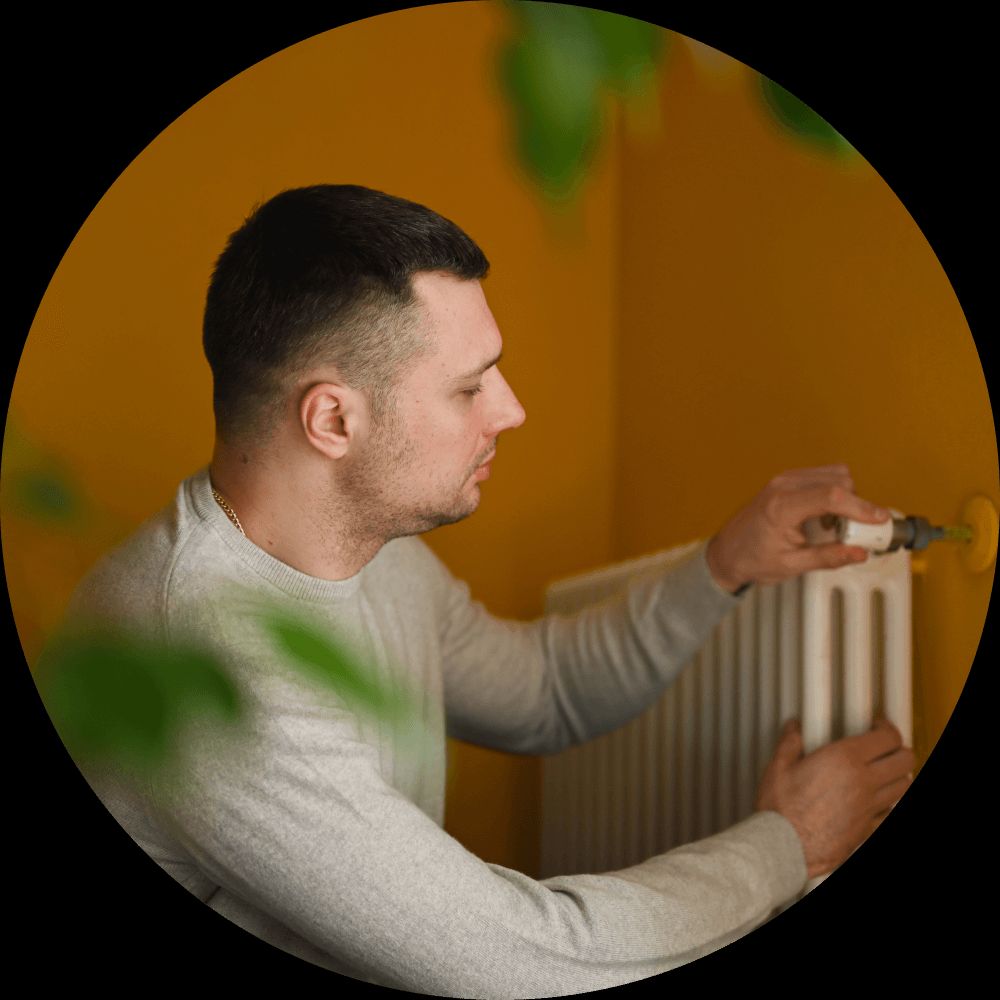 man fixing radiator
